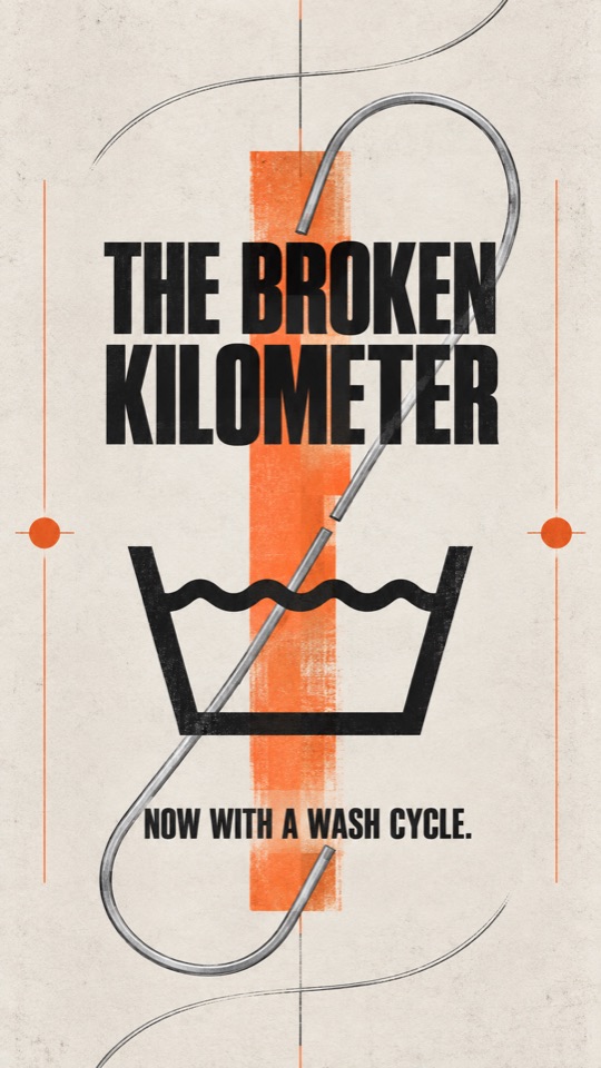 Vertical poster reading ‘The Broken Kilometer—now with a wash cycle,’ with a broken silver line threaded through a laundry-tub symbol.